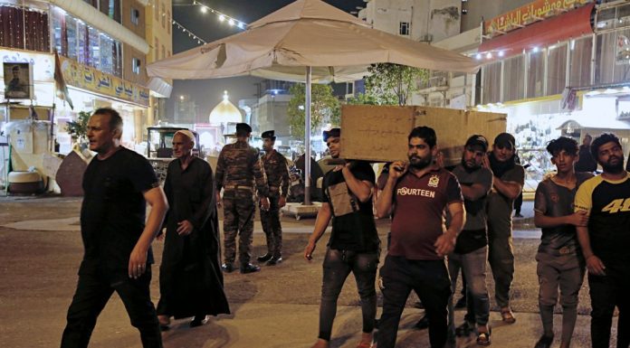 Masked gunmen attack protesters in Iraq holy city; 18 killed